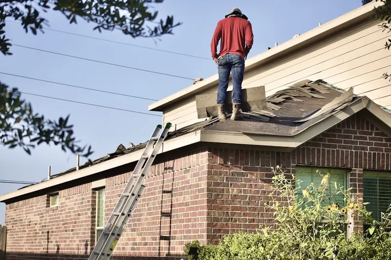 Professional roofer working on a residential roof in Tetersburg